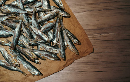 Lots of sun dried fish on the paper.