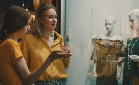 Family looking at the shop window of clothing store.の写真素材