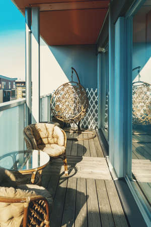 Modern large balcony with furniture on the top floor.の写真素材