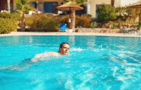 Man swimming in outdoor swimming pool.の写真素材