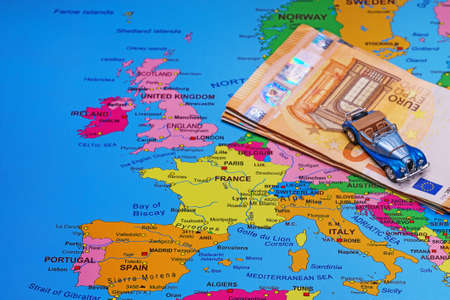 Convertible car and euro banknotes on a map of Europe.の写真素材
