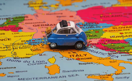 Small toy retro car in the middle of Europe map. Travel by car concept.の写真素材