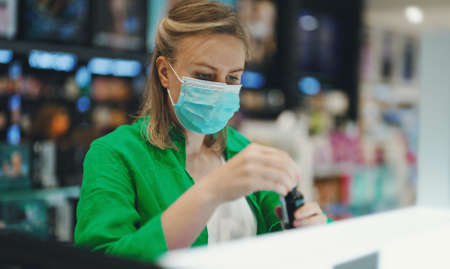 Woman trying cosmetics products in the cosmetics store.の写真素材
