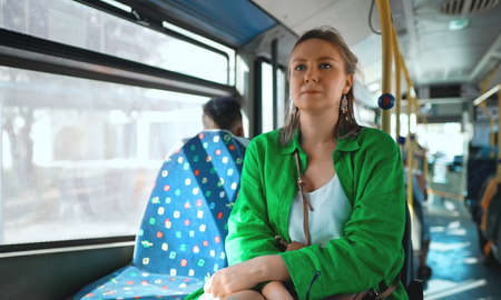Woman rides a bus in summer.の写真素材