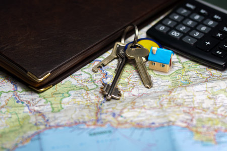 Toy house, keys and calculator. Real estate purchase concept.