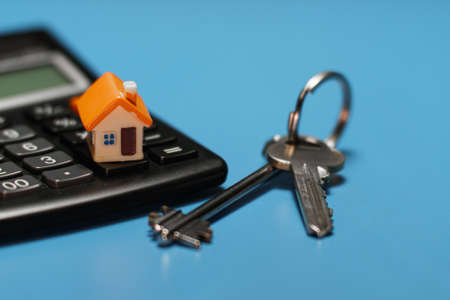 Toy house, keys and calculator. Real estate purchase concept.の写真素材
