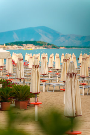 Sun loungers and umbrellas on the private beach.の写真素材