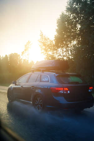 Car going on the road after the rain.の写真素材