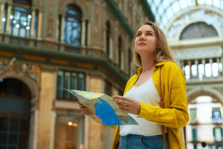 Woman tourist with map stands in the Galleria Umberto in Naples.