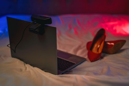 Laptop with webcam on the bed. Adult webcam work concept.の写真素材