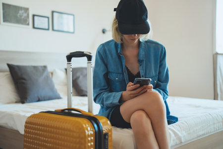 Teenage girl got ready before everyone else and is waiting to go on vacation.の写真素材