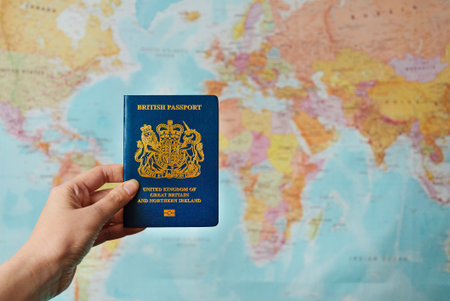 United Kingdom of Great Britain passport in front of world map.