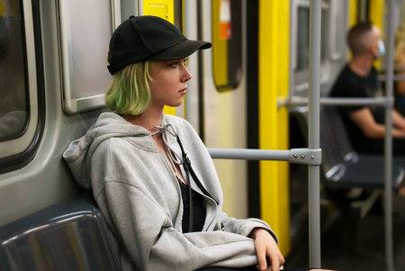 Teenage girl rides in a subway train.