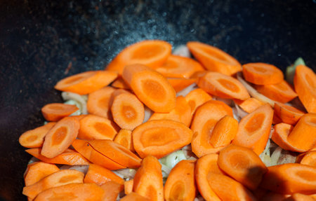 Carrot is cooked in cauldron on fire. Step by step cooking of Chorba.の写真素材
