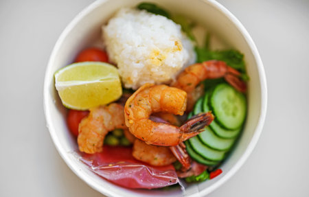 Store-bought poke bowl with shrimp and rice.