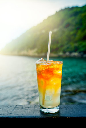 Glass of Mai Tai cocktail in front of the sea background.の写真素材
