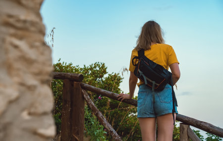 Woman tourist with backpack visits the nature reserve park.の写真素材