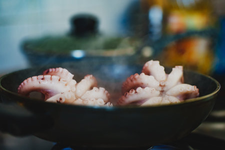 Cooking small octopuses in frying pan.