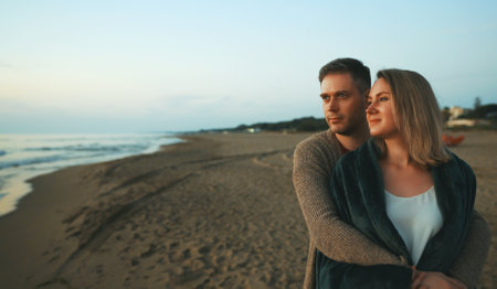 Attractive couple at sunset by the sea.の写真素材