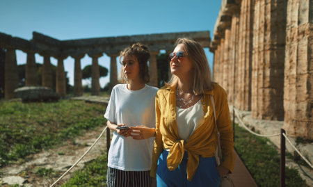 Family of tourists walks around the ancient city.の写真素材