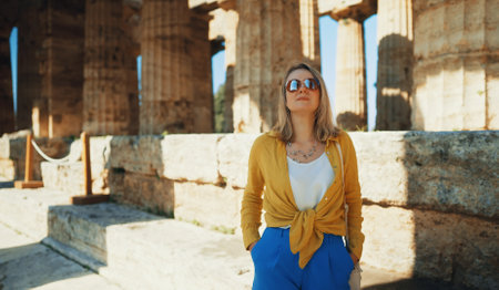 Woman tourist enjoys the views of the old temple.の写真素材