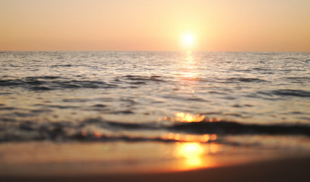 Sunset on a sandy beach on the sea.の写真素材