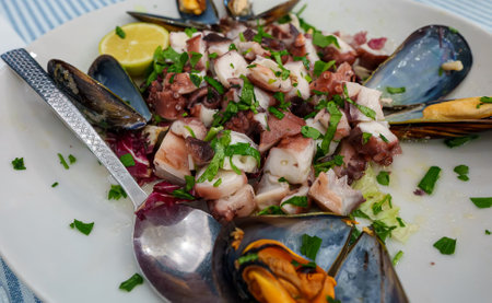 Traditional salad with octopus and herbs.の写真素材