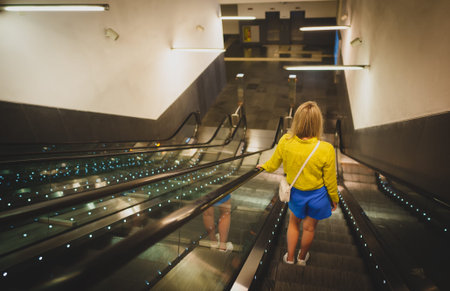 Woman using the escalator in the subway.