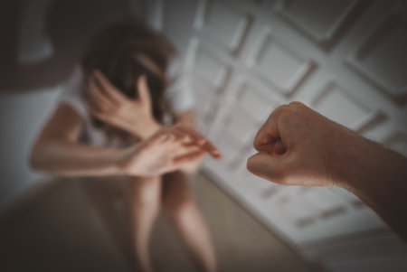 Man beats the woman with his fist. Victim of domestic violence.の写真素材