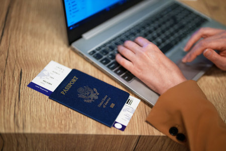 Woman with USA passport is waiting for her flight.の写真素材