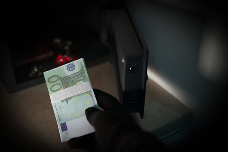 Thief steals money from a steel safe.の写真素材