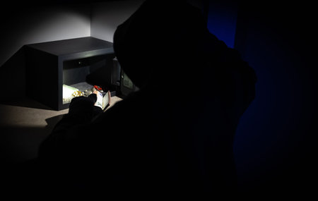 Female thief steals money from a steel safe.