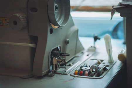 Sewing machine and threads on the table.の写真素材