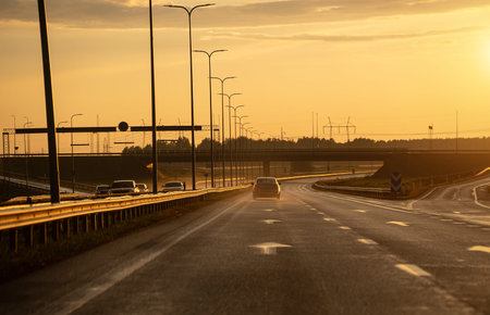 Highway after the rain at sunset in summer.