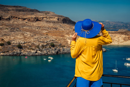 Woman in a hat on holiday at sea.