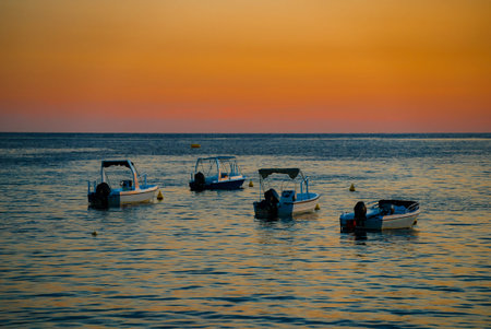 Many boats at sunset in the bay.