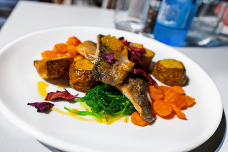 Seabass fillet with potatoes in a restaurant.