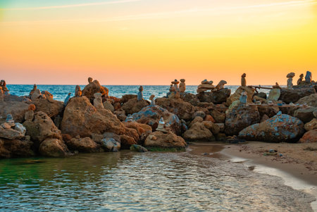 Many ZEN stones on the sunset beach.の写真素材