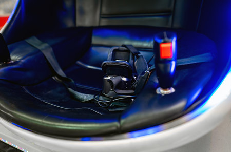 Virtual reality helmet in a special chair with controls.