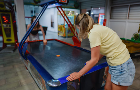 Family plays air hockey in the entertainment center.