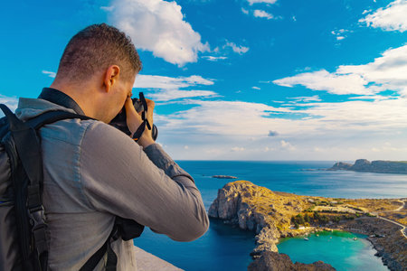 Man takes a photograph of Saint Pauls Bay.