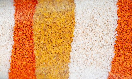 White rice, yellow rice and lentils in a jar.の写真素材