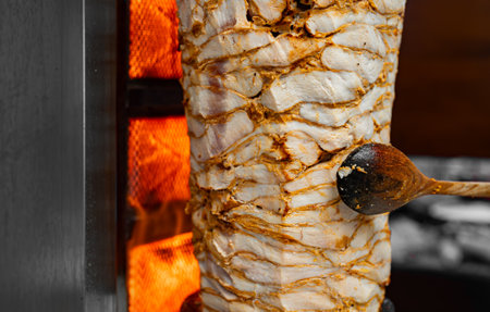 Juicy meat is fried on a shawarma spit.の写真素材