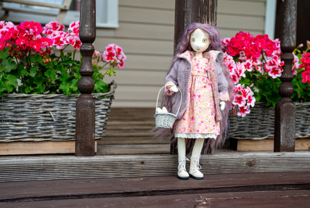 Handmade doll of a girl with long pink hair.の写真素材