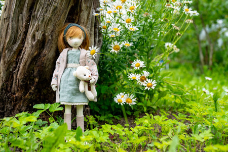 Handmade doll of a girl with a bear. Children's toy.の写真素材