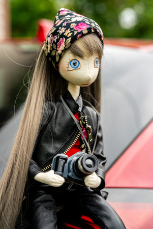 Handmade doll of a photographer girl. Children's toy.