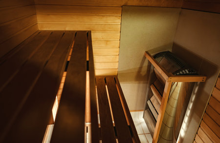 Cozy wooden sauna with benches and a heated stove.