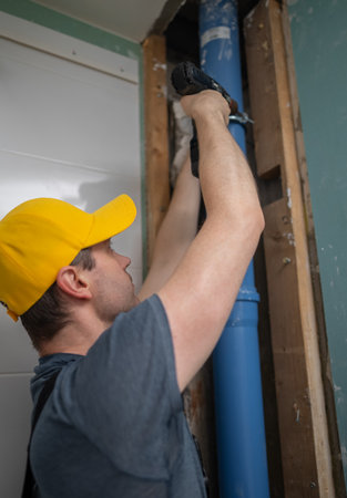 A man installing a new sewer drain stack.の写真素材