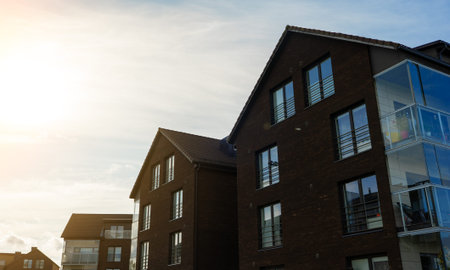 Modern apartment building with large glass windows and balconies.の写真素材