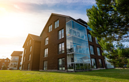 Modern apartment building with large glass windows and balconies.の写真素材